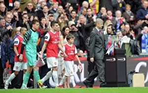 Arsene Wenger the Arsenal Manager and Robin van Persie (Arsenal) lead out the team