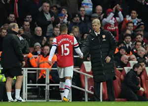 Arsene Wenger the Arsenal Manager shakes hands with Alex Oxlade-Chamberlain (Arsenal)