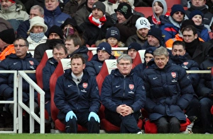 Arsenal v Everton 2009-10 Gallery: Arsene Wenger the Arsenal Manager sits on the bench with Pat Rice (Assistant Manager)