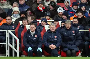Arsene Wenger the Arsenal Manager sits on the bench with Pat Rice (Assistant Manager)