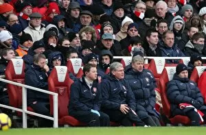 Images Dated 9th January 2010: Arsene Wenger the Arsenal Manager sits with Colin Lewin (Physio) and Pat Rice
