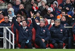 Images Dated 9th January 2010: Arsene Wenger the Arsenal Manager sits in the Dug Out with Pat Rice (Assistant)