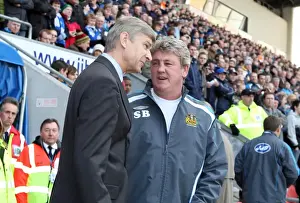 Arsene Wenger the Arsenal Manager speaks to Steve Bruce the Wigan Manager before the match