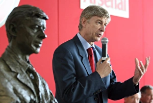Arsene Wenger the Arsenal Manager stands near his bust