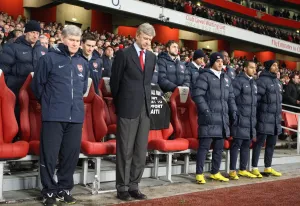 Arsenal V Bolton 2009-10 Prints: Arsene Wenger the Arsenal Manager and the subs bench bow their heads for a minutes silence for the Haiti disaster