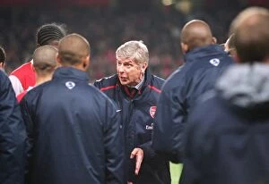 Arsene Wenger the Arsenal Manager talks to his players before the start of extra time