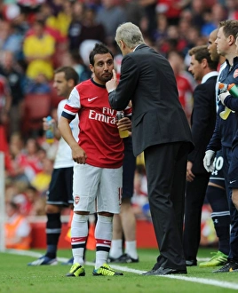 Arsene Wenger Conferring with Santi Cazorla during Arsenal vs. Tottenham Rivalry (2013-14)