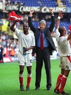 Arsene Wenger and Lauren celebrate at the end of the match