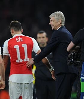 Images Dated 20th October 2015: Arsene Wenger and Mesut Ozil: Celebrating Arsenal's Goal Against Bayern Munich in the 2015