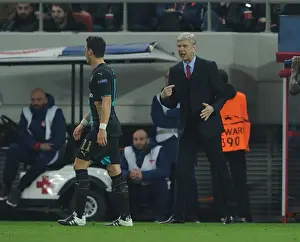 Olympiacos V Arsenal 2015-16 Prints: Arsene Wenger and Mesut Ozil: A Strategic Discussion Amidst the Champions League Battle (Olympiacos vs)