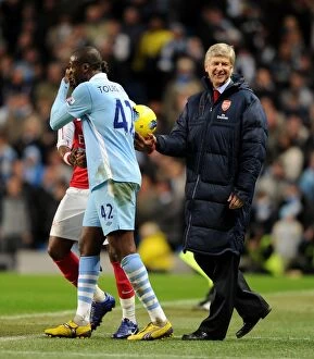 Images Dated 18th December 2011: Arsene Wenger and Yaya Toure Share a Light-Hearted Moment Amidst Manchester City vs