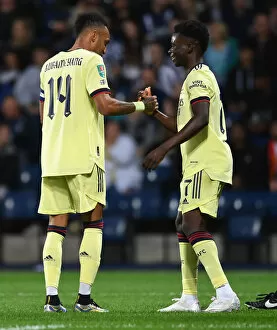 Images Dated 25th August 2021: Aubameyang and Saka Celebrate Arsenal's Goal Against West Bromwich Albion in Carabao Cup