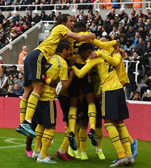 Aubameyang Strikes: Guendouzi and Mkhitaryan Celebrate Arsenal's Winning Goal vs. Newcastle United