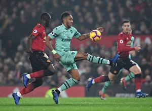 Manchester United v Arsenal 2018-19 Collection: Aubameyang vs. Bailly: A Premier League Showdown at Old Trafford