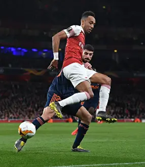 Arsenal V Valencia 2018-19 Prints: Aubameyang vs Piccini: Intense Battle in Arsenal's Europa League Semi-Final Clash with Valencia