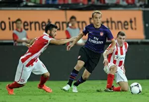 Images Dated 12th September 2012: Austin Lipman (Arsenal) Emmanouil Siopis and Dimitrios Voutsiotis (Olympiacos)