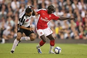 Images Dated 26th September 2009: Bacary Sagna (Arsenal) Clint Dempsey (Fulham)