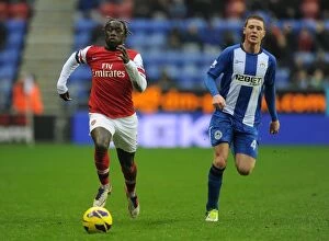 Images Dated 22nd December 2012: Bacary Sagna Outruns James McCarthy: Wigan Athletic vs Arsenal, Premier League, 2012