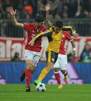 Images Dated 15th February 2017: Battle of Midfield: Alexis Sanchez vs Xabi Alonso - Arsenal vs Bayern Munich