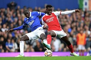 Everton v Arsenal 2023-24 Collection: Battle for Possession: Doucoure vs. Nketiah - Intense Rivalry in the 2023-24 Premier League Clash