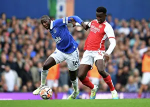Battle for Possession: Everton's Doucoure vs. Arsenal's Nketiah in the 2023-24 Premier League Clash