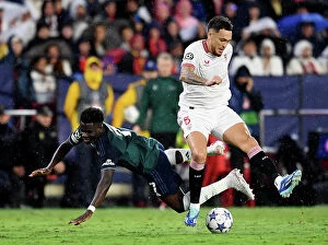 Images Dated 25th October 2023: Battling for Possession: Sevilla vs. Arsenal - UEFA Champions League 2023/24
