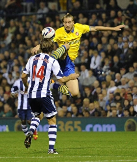 West Bromwich Albion V Arsenal 2013-14 - Capital Cup Prints: Bendtner vs. Laguno: Arsenal's Edge in the Capital One Cup Clash (West Bromwich Albion vs)