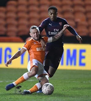 Images Dated 5th January 2019: Blackpool vs Arsenal: FA Cup Third Round Clash - Joe Willock Faces Off Against Jay Spearing