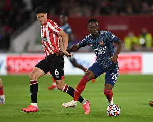Brentford V Arsenal 2021-22 Prints: Brentford vs Arsenal: Intense Clash in Premier League - Flo Balogun vs Christian Norgaard