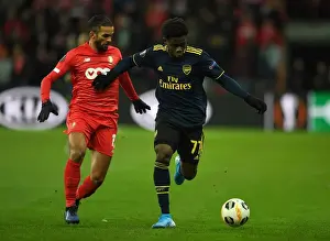 Standard Liege V Arsenal 2019-20 Prints: Bukayo Saka Faces Off Against Mehdi Carcela in Standard Liege vs