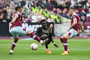 West Ham United V Arsenal 2022-23 Prints: Bukayo Saka Takes Shot Amid Pressure from West Ham's Kehrer and Cresswell - Arsenal vs West Ham