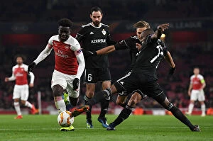 Images Dated 13th December 2018: Bukayo Saka vs. Donald Guerrier: A Football Showdown at Emirates Stadium - Arsenal vs