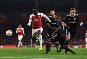 Images Dated 13th December 2018: Bukayo Saka vs. Donald Guerrier: Arsenal vs. Qarabag Football Battle, UEFA Europa League 2018-19