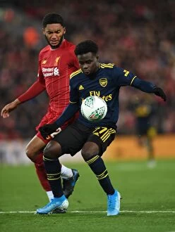 Images Dated 31st October 2019: Bukayo Saka vs Joe Gomez: A Footballing Battle at Anfield - Carabao Cup Showdown