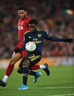 Images Dated 31st October 2019: Bukayo Saka vs Joe Gomez: Intense Battle at Anfield - Carabao Cup 2019-20