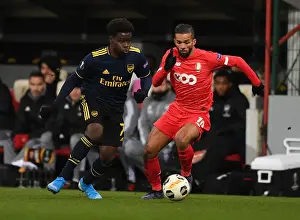 Standard Liege V Arsenal 2019-20 Prints: Bukayo Saka vs. Mehdi Carcela: A Europa League Showdown at Standard Liege