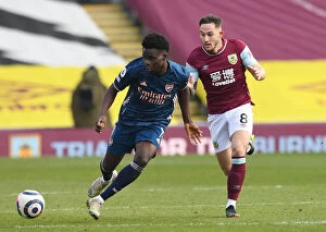 Burnley v Arsenal 2020-21 Collection: Burnley vs Arsenal: Saka Takes on Brownhill in Empty Turf Moor, Premier League 2020-21