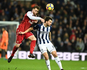 Calum Chambers vs Jay Rodriguez: A Tense Heading Duel in Arsenal's Premier League Battle with West Bromwich Albion (2017-18)