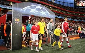 Captains Cesc Fabregas (Arsenal) and Carles Puyol (Barcelona) walk out with the mascots