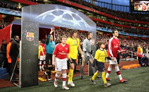Captains Cesc Fabregas (Arsenal) and Carles Puyol (Barcelona) walk out with the mascots Captains Cesc Fabregas (Arsenal) and Carles Puyol (Barcelona) walk out with the mascots
