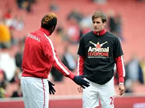 Carl Jenkinson and Alex Song (Arsenal) warm up in thier Arsenal for Everyone T Shirt