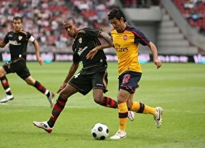 Arsenal v Seville Collection: Carlos Vela beats Seville defender Abdoulay Konko to
