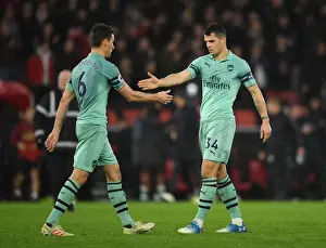 Celebrating Victory: Koscielny and Xhaka High-Five After Arsenal's Win Against Southampton (2018-19)