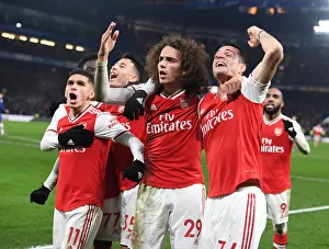 Celebrating Victory: Torreira, Guendouzi, and Xhaka Rejoice After Arsenal's Goal vs. Chelsea (Premier League 2019-20)