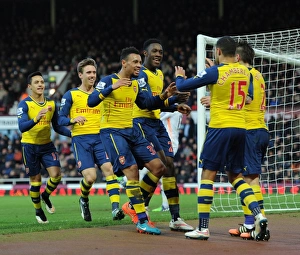 Celebrating Victory: Welbeck, Coquelin, and Oxlade-Chamberlain Rejoice After Arsenal's Goals vs. West Ham United (2014-15)
