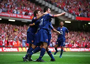 Cesc Fabrages and Robin van Persie celebrate Arsenal 3rd gaol with Goalscorer Ashley Cole