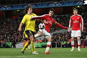 Images Dated 31st March 2010: Cesc Fabregas (Arsenal) is fouled by Carles Puyol (Barcelona) resulting in a penalty for Arsenal