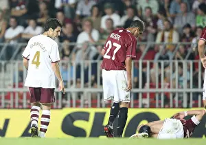 Cesc Fabregas (Arsenal) looks at injured Sparta Prague captain Tomas Repka