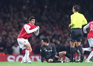 Cesc Fabregas (Arsenal) shows the referee that his shirt was being pulled