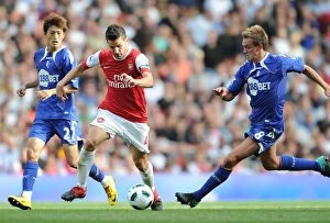 Arsenal v Bolton Wanderers 2010-11 Collection: Cesc Fabregas (Arsenal) Stuart Holden and Chung-Yong Lee (Bolton). Arsenal 4